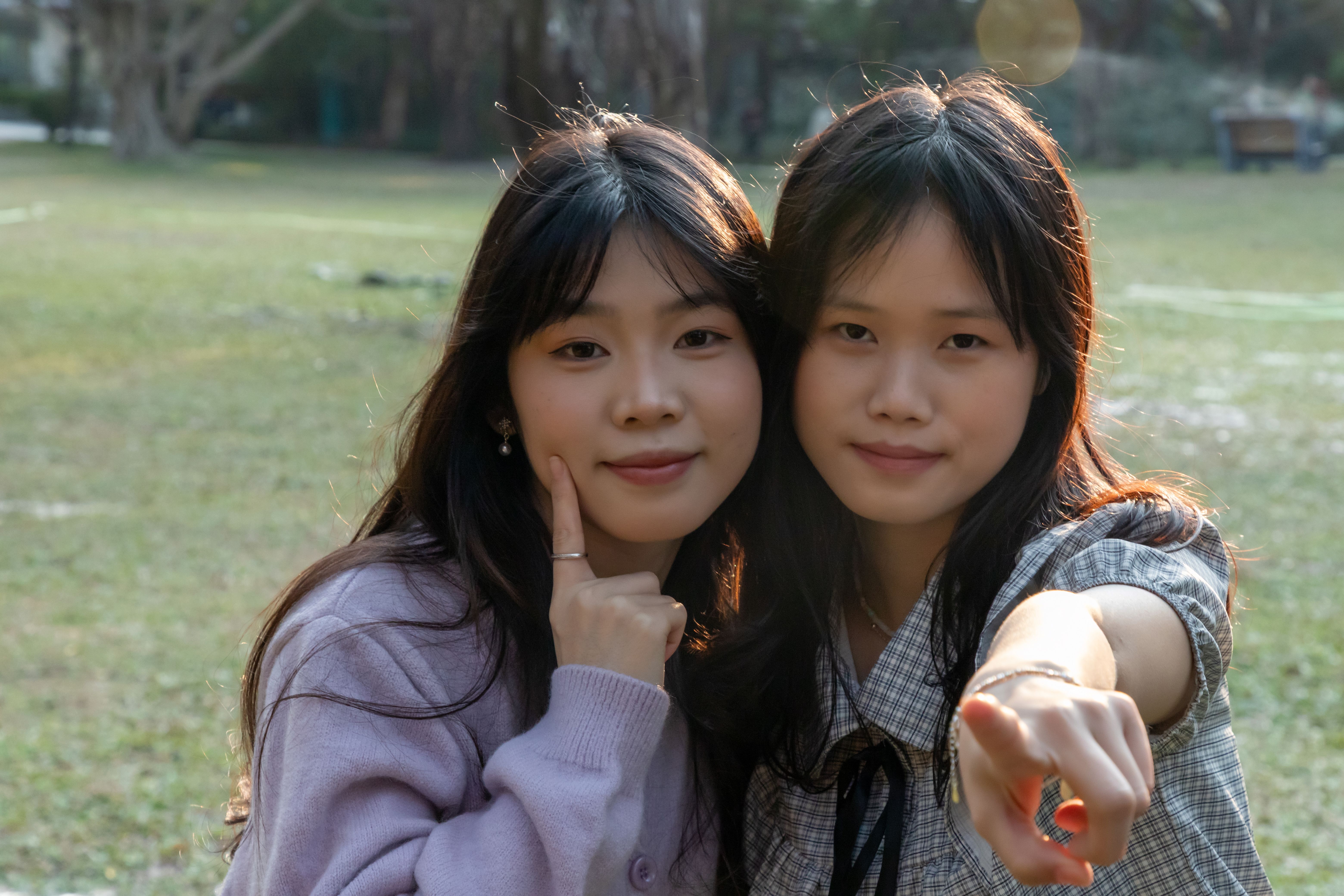 Two Friends Smiling in a Sunlit Park · Free Stock Photo
