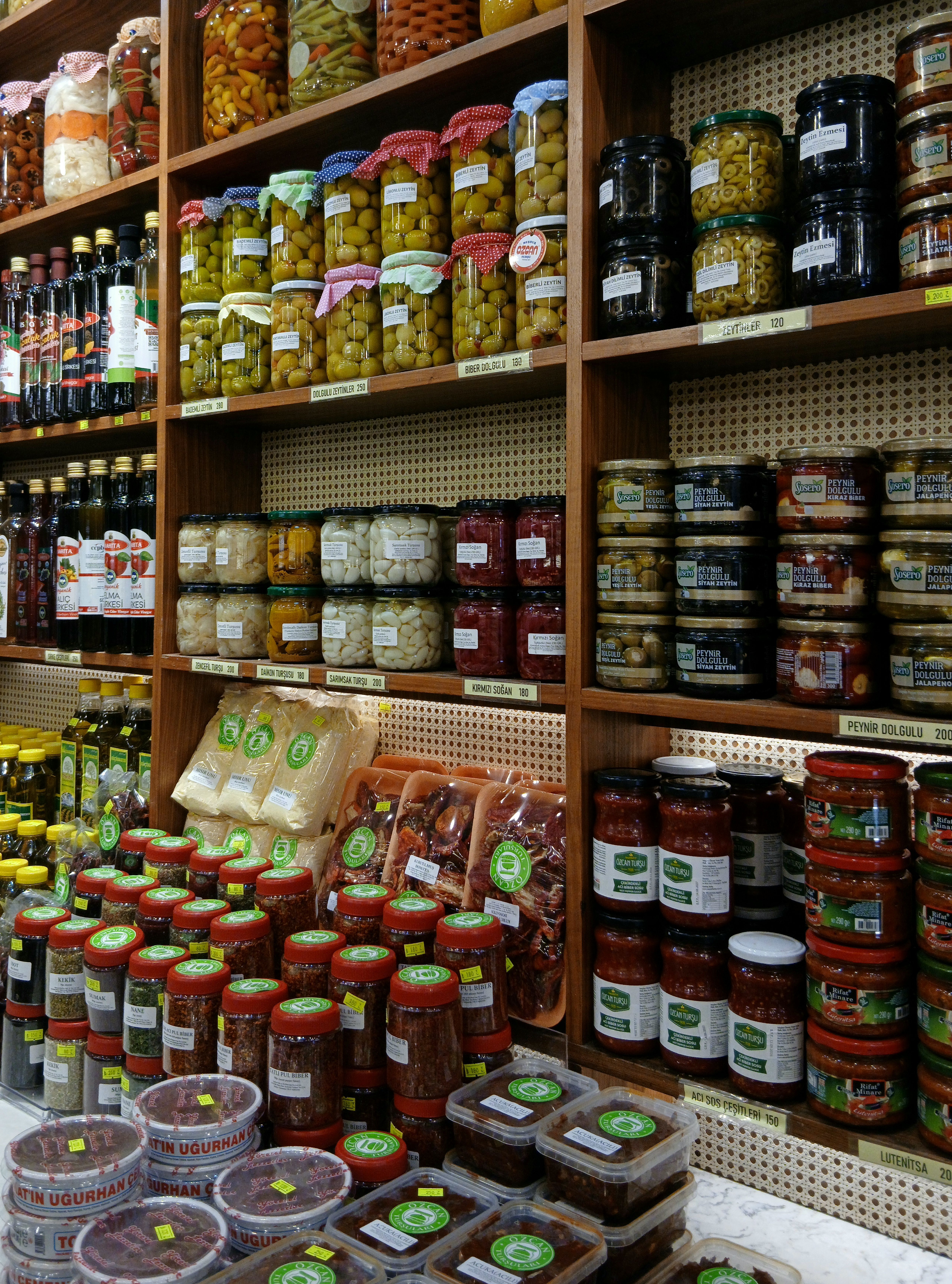 Colorful display of preserved food jars, a vibrant showcase in a grocery store aisle.