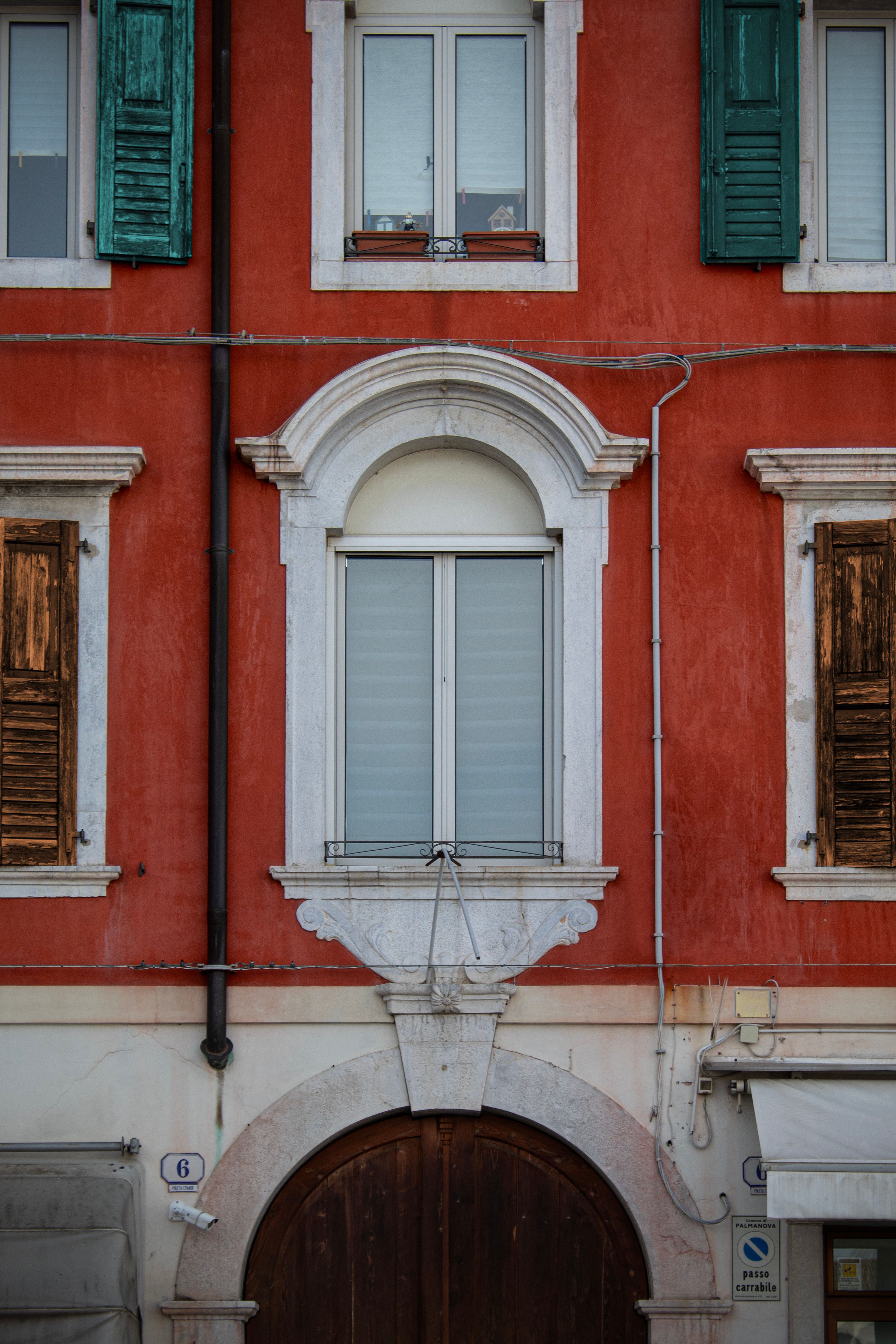 Vibrant facade with classic Italian architectural details in Palmanova, Friuli-Venezia Giulia.