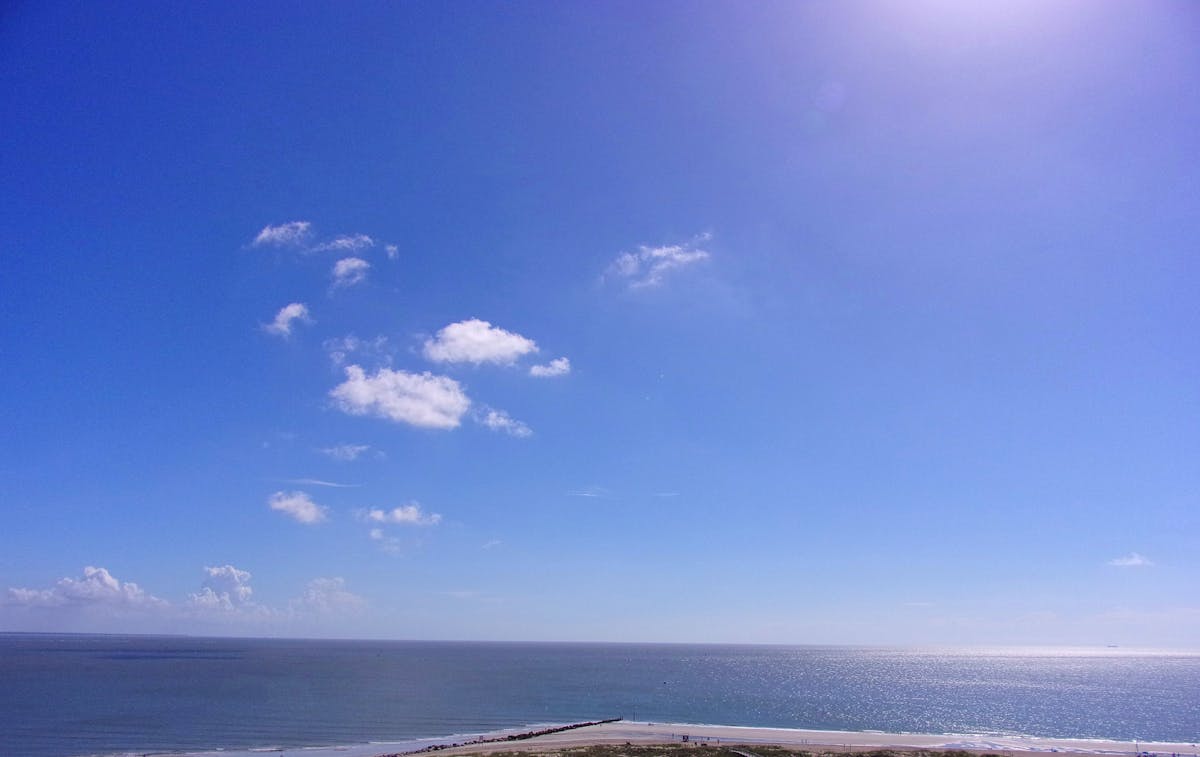 Person meditating on a yoga mat with headphones on