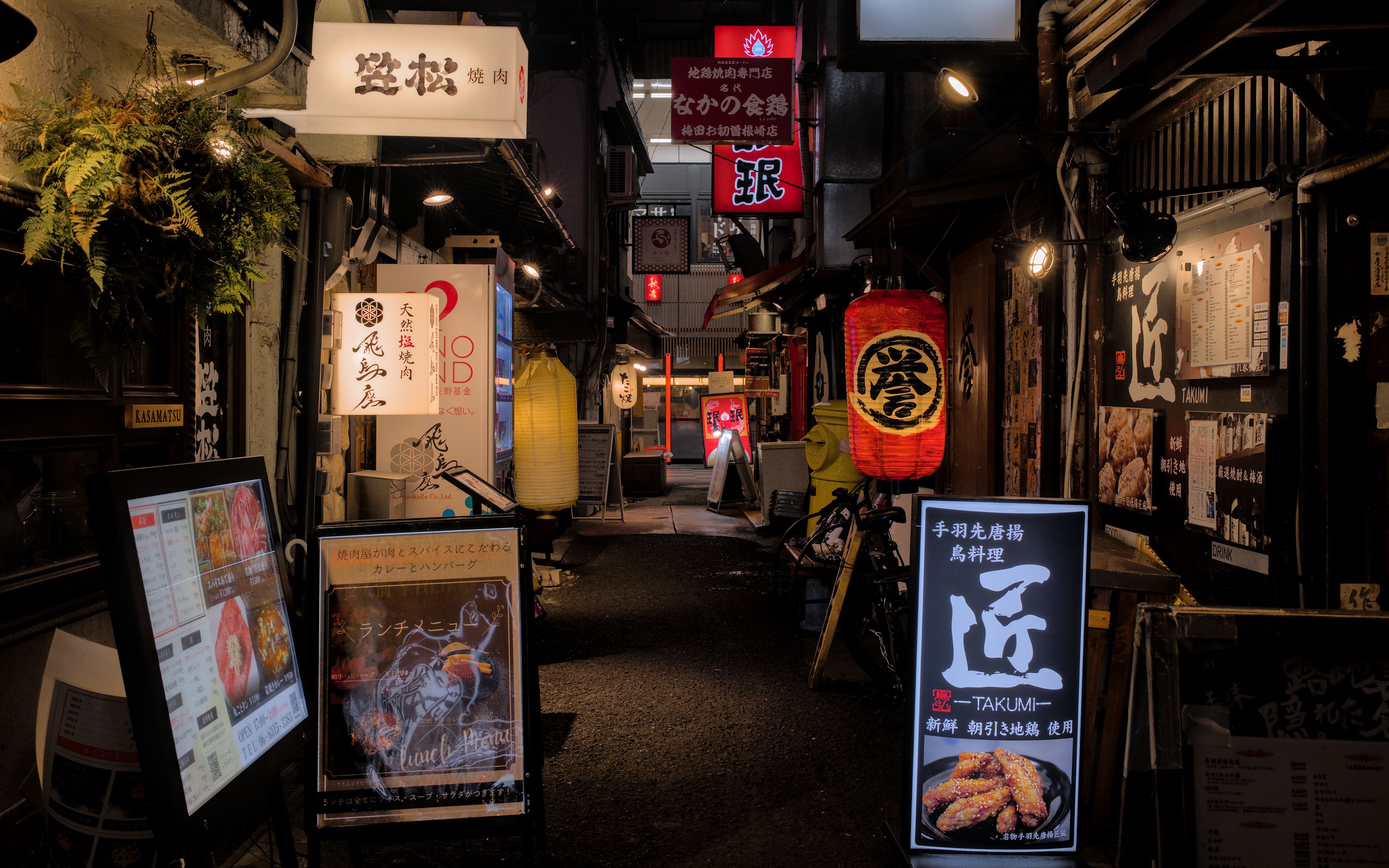 Takoyaki octopus balls being cooked on a griddle in Osaka