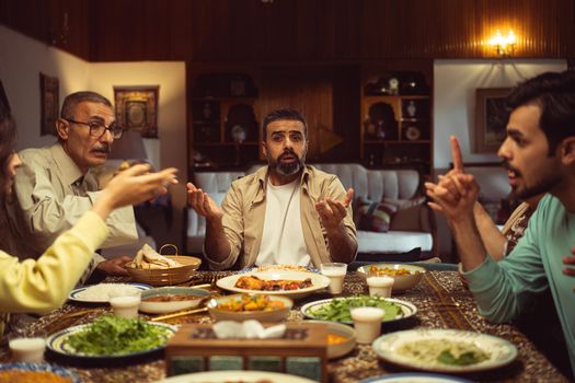 A family engaging in conversation over a traditional meal, fostering connection.