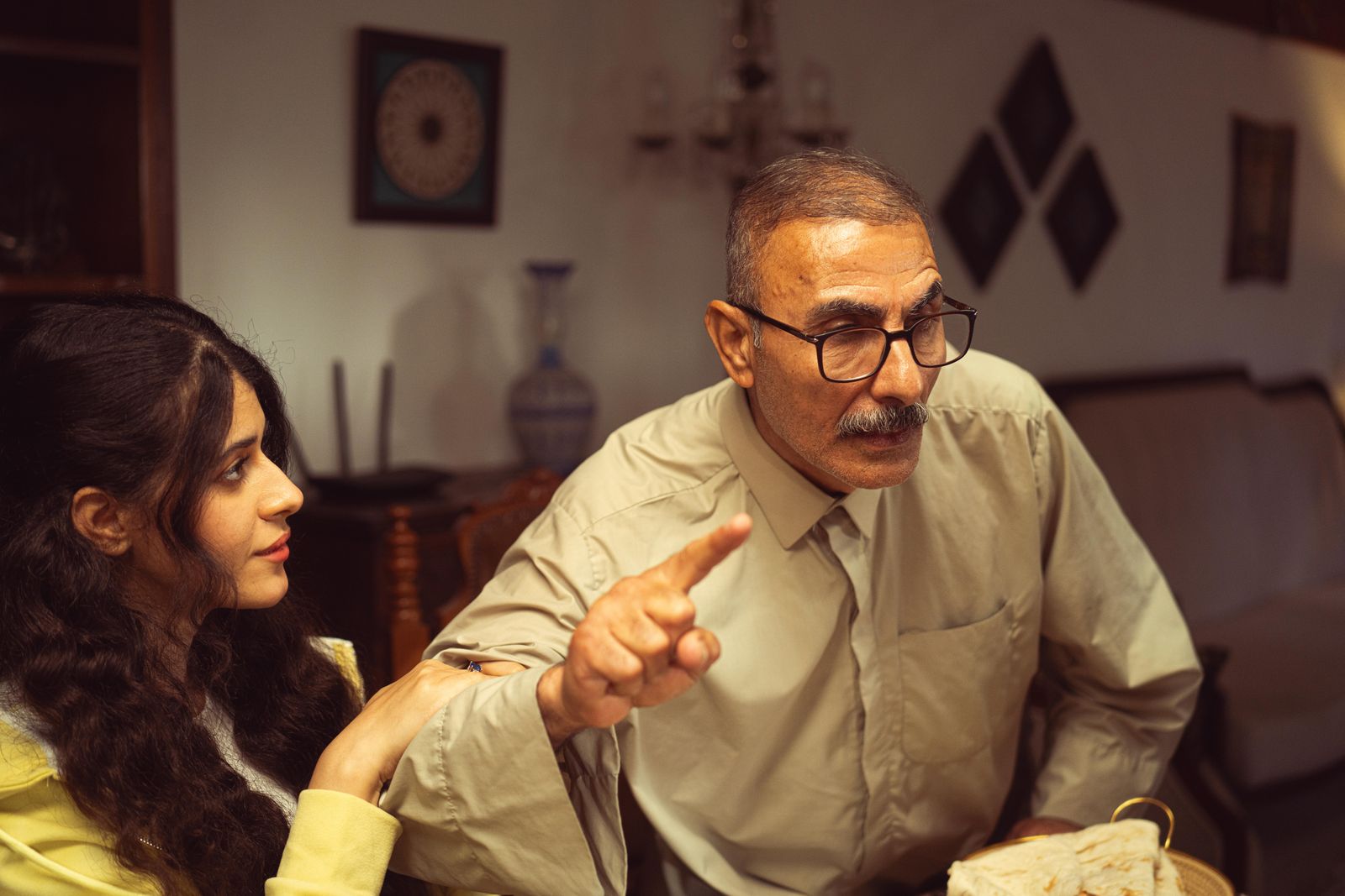 Older parent and adult child discussing a difficult issue in a private setting