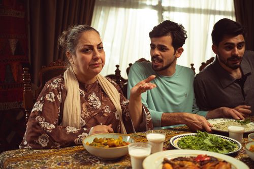 Free A close-knit family savoring a homemade Middle Eastern meal around a cozy dining table. Stock Photo