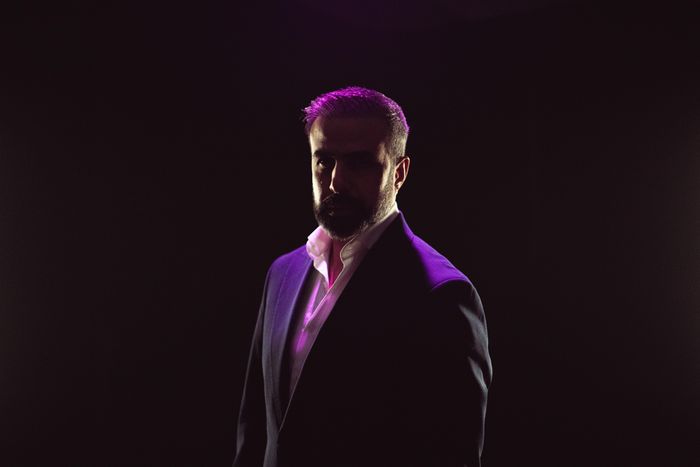 A dramatic, moody portrait of a man in a suit. Photo by khezez on Pexels