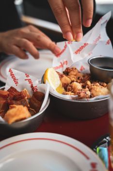 Close-up of Spanish tapas served with lemon on a table, highlighting diverse flavors.