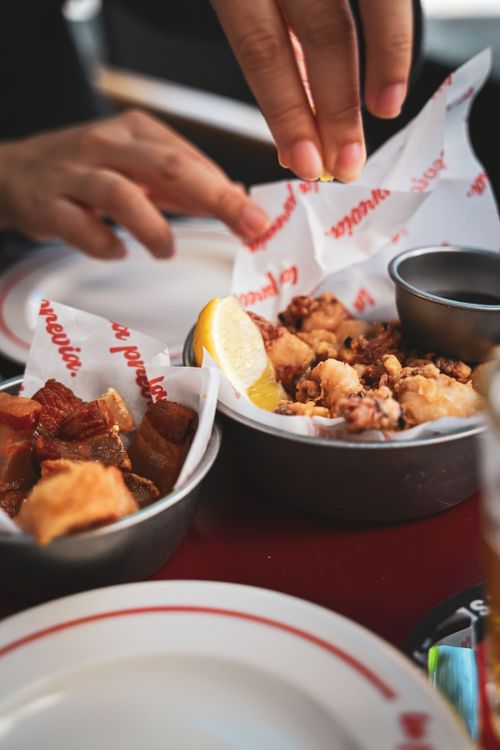 Free Close-up of Spanish tapas served with lemon on a table, highlighting diverse flavors. Stock Photo