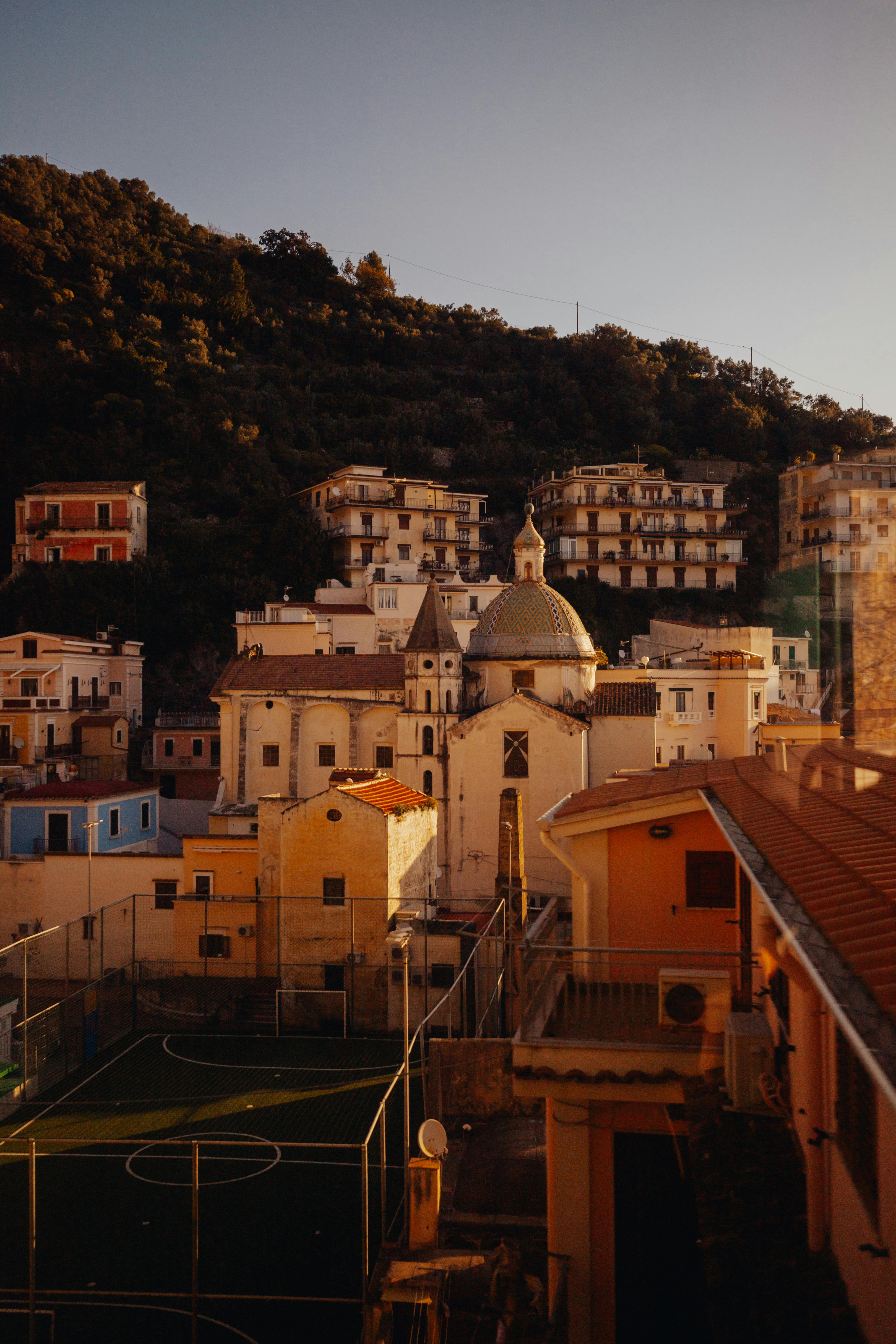 Charming Italian village featuring historic architecture and a serene landscape at sunset.