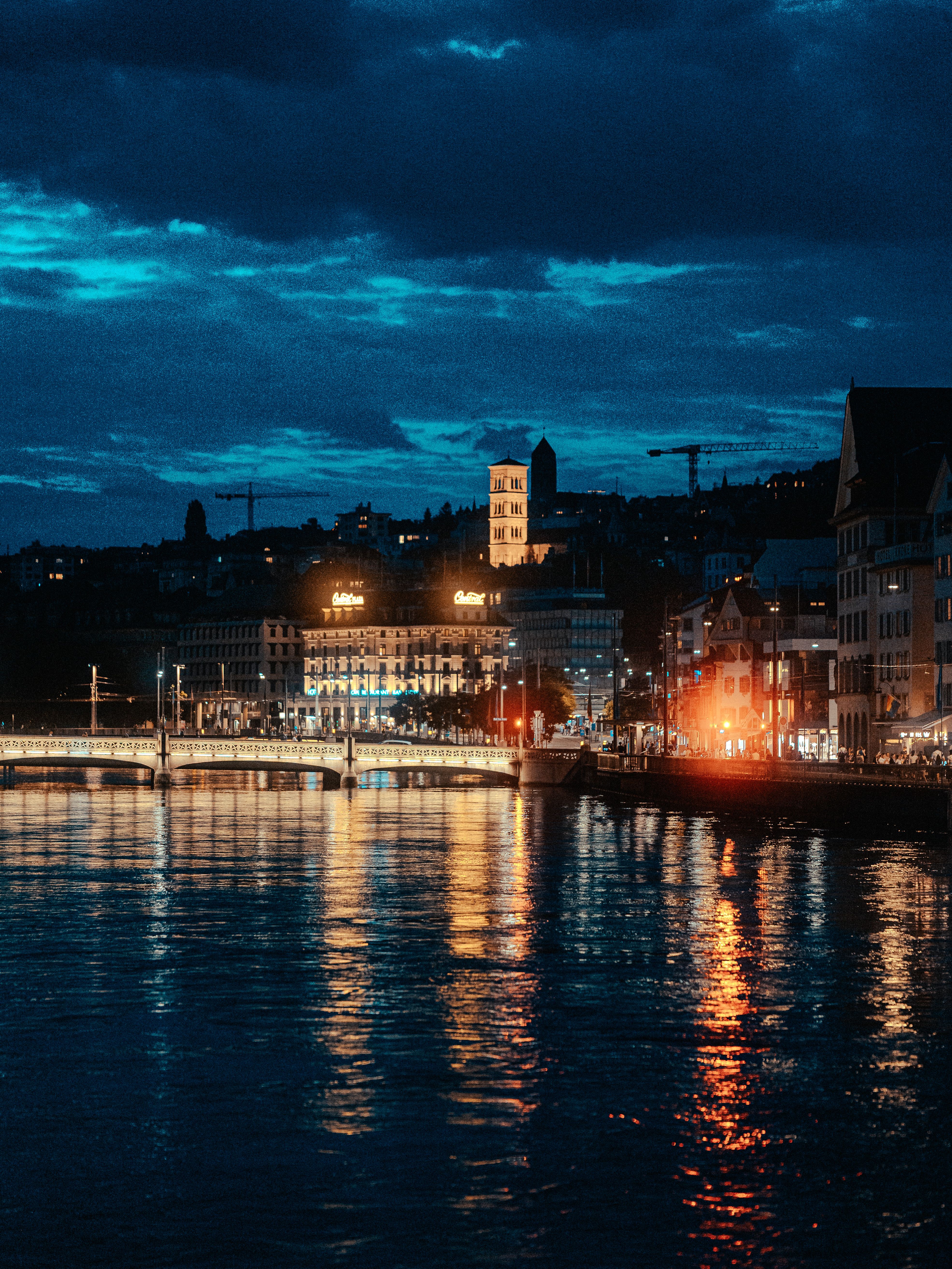Stunning Night View of City Lights Reflecting on Water · Free Stock Photo