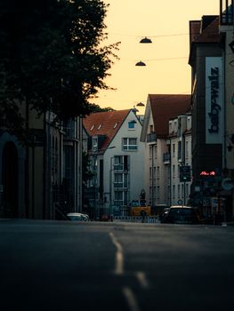 A serene street scene at dusk featuring classic European architecture under a warm sky.