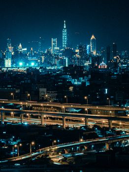 Vibrant cityscape featuring a skyscraper-lit skyline with flowing traffic at night.