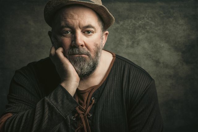 Portrait of a bearded man in a felt hat — photo by Murry Lee on Pexels
