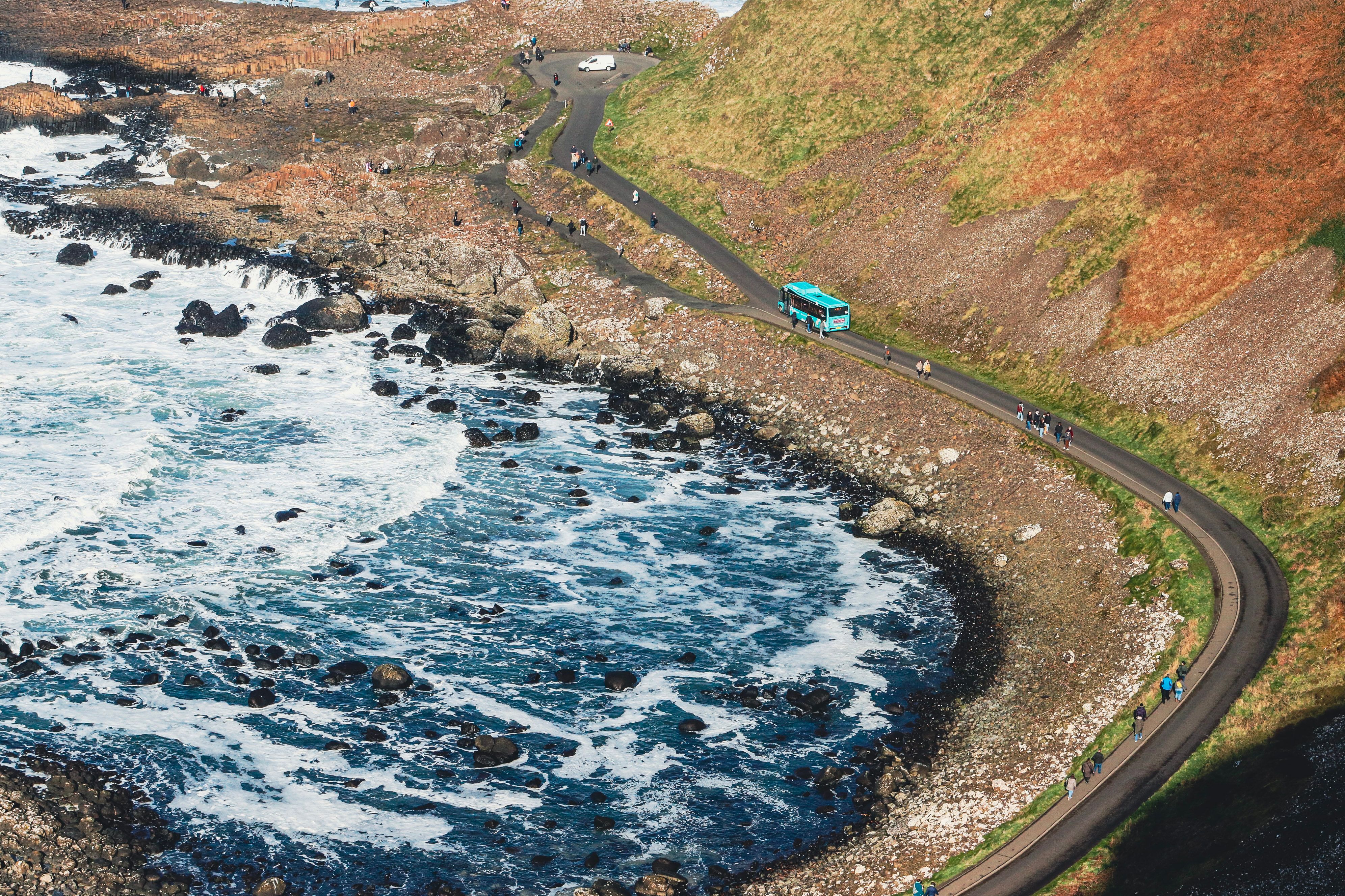 A scenic view of the coastal road winding along Giant's Causeway in Northern Ireland.