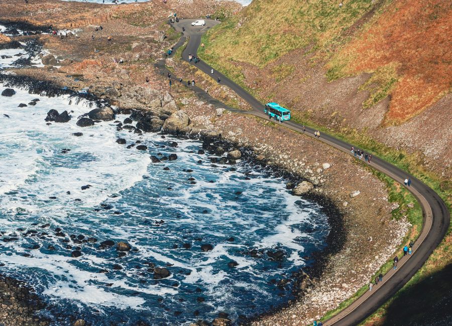 A scenic view of the coastal road winding along Giant's Causeway in Northern Ireland.