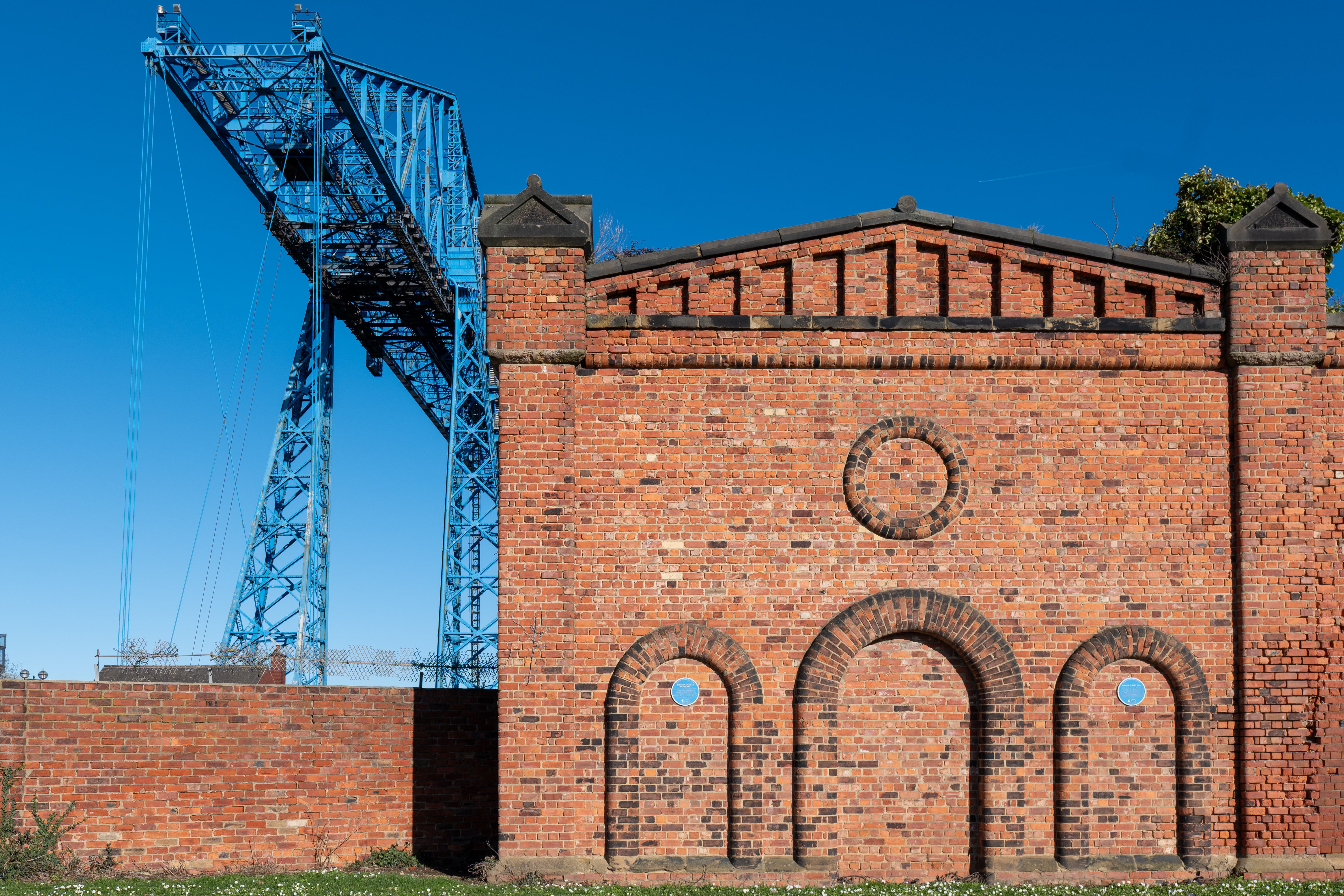 Historic Transporter Bridge and brick building in Middlesbrough, England, showcasing industrial heritage.