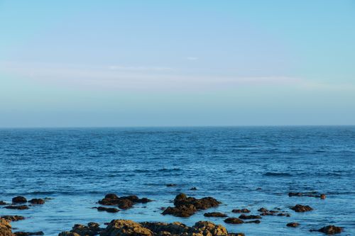 Free Captivating view of the rugged Monterey coastline meeting the expansive blue ocean. Stock Photo