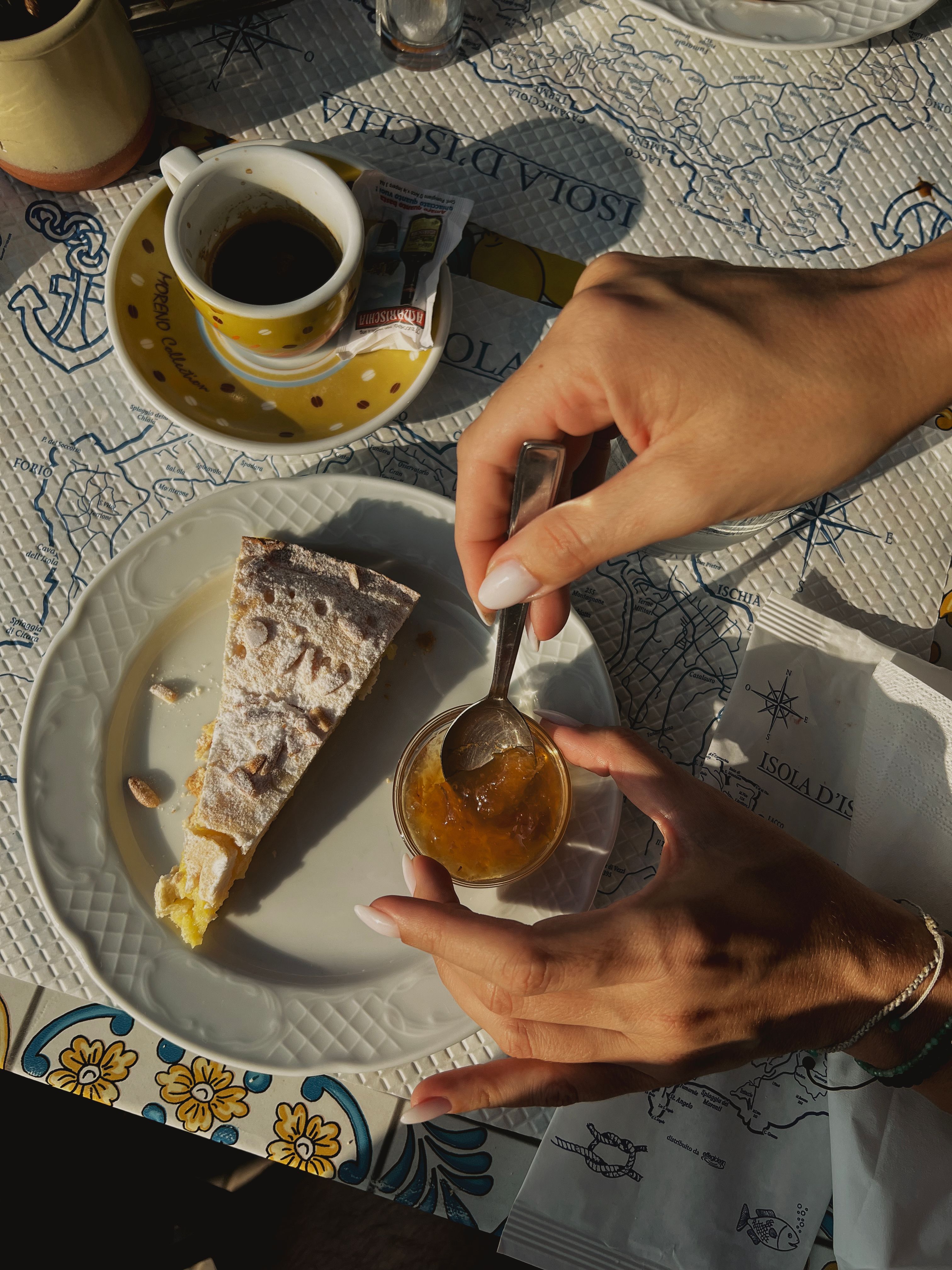 Enjoying traditional Italian dessert and espresso in Ischia, Italy.