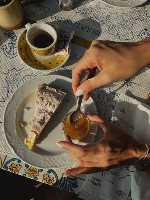 Enjoying traditional Italian dessert and espresso in Ischia, Italy.