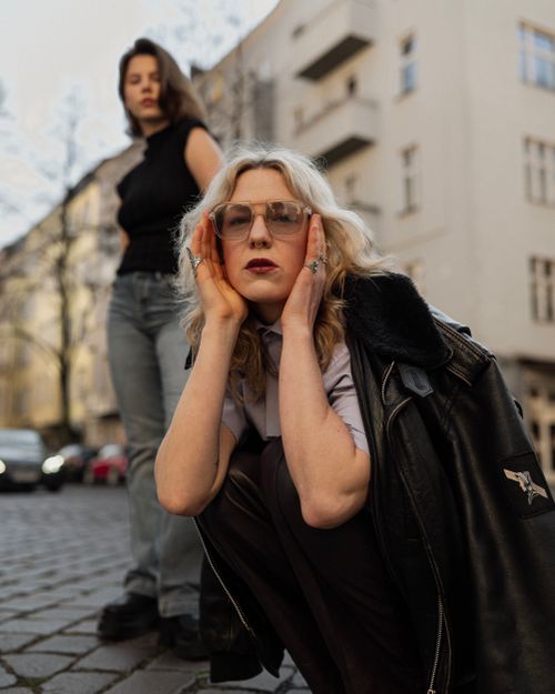 Free Two women pose stylishly on a Berlin street. Fashion and urban vibes. Stock Photo