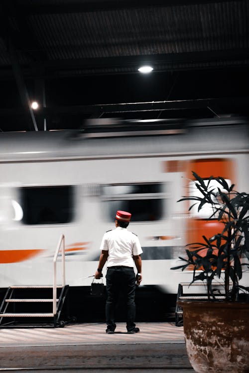 無料 公共交通機関と赤い帽子をかぶった男 写真素材