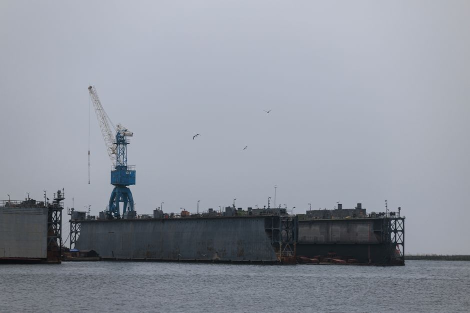 Aerial view of a shipyard with cranes and docked ships in Baltiysk, Russia.
