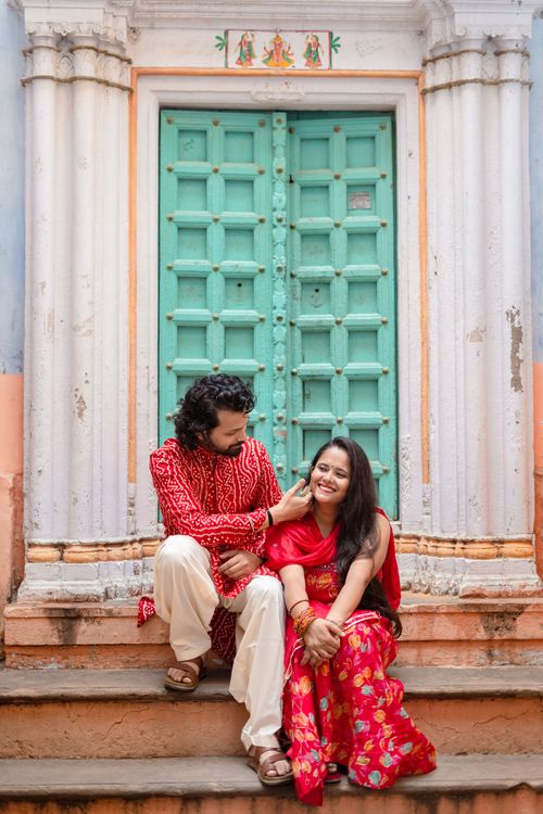 Free A couple in traditional Indian attire sitting on steps in Varanasi, exuding romance and cultural elegance. Stock Photo