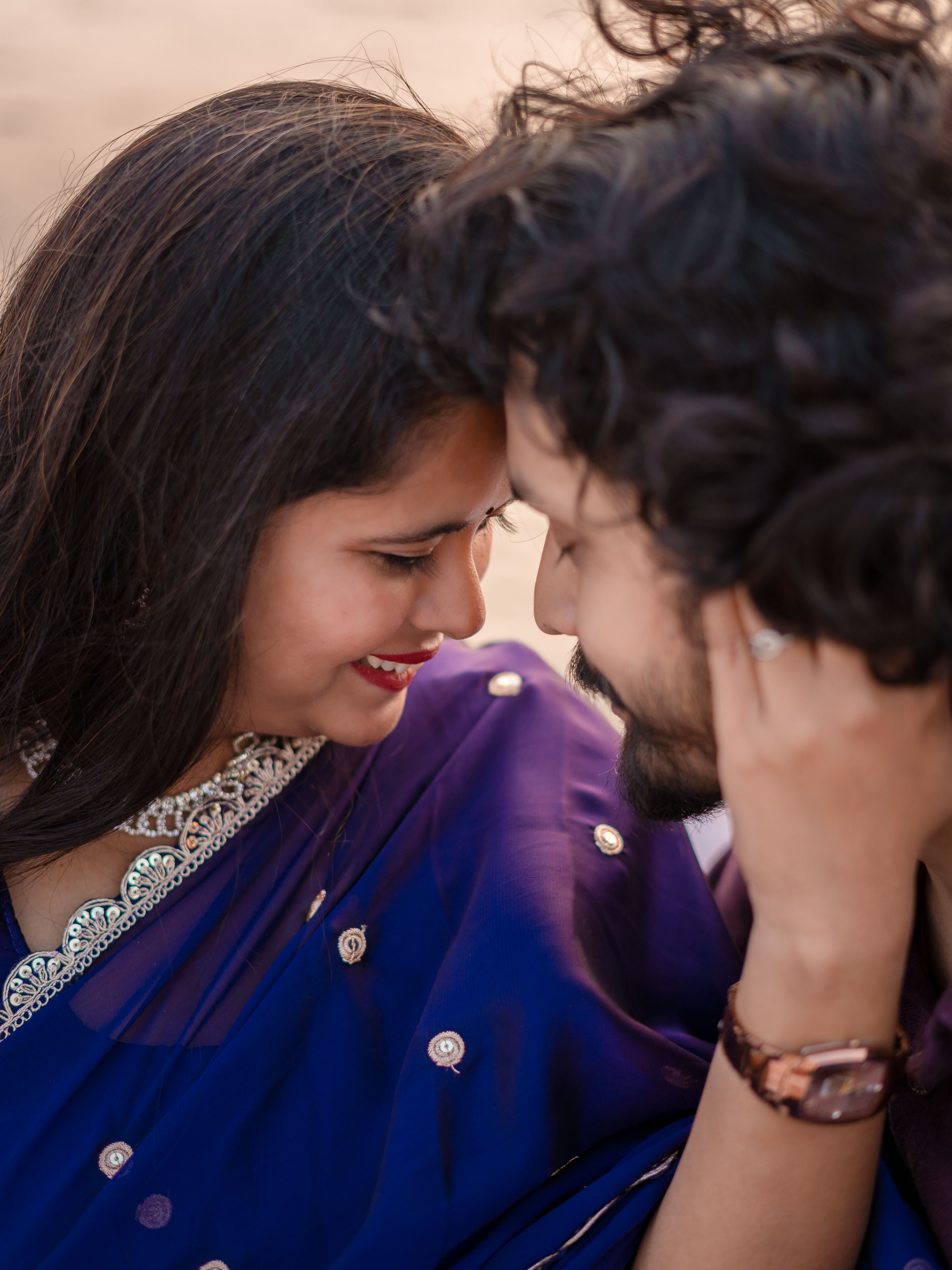Close-up of a loving couple embracing in Varanasi, dressed elegantly in traditional attire.