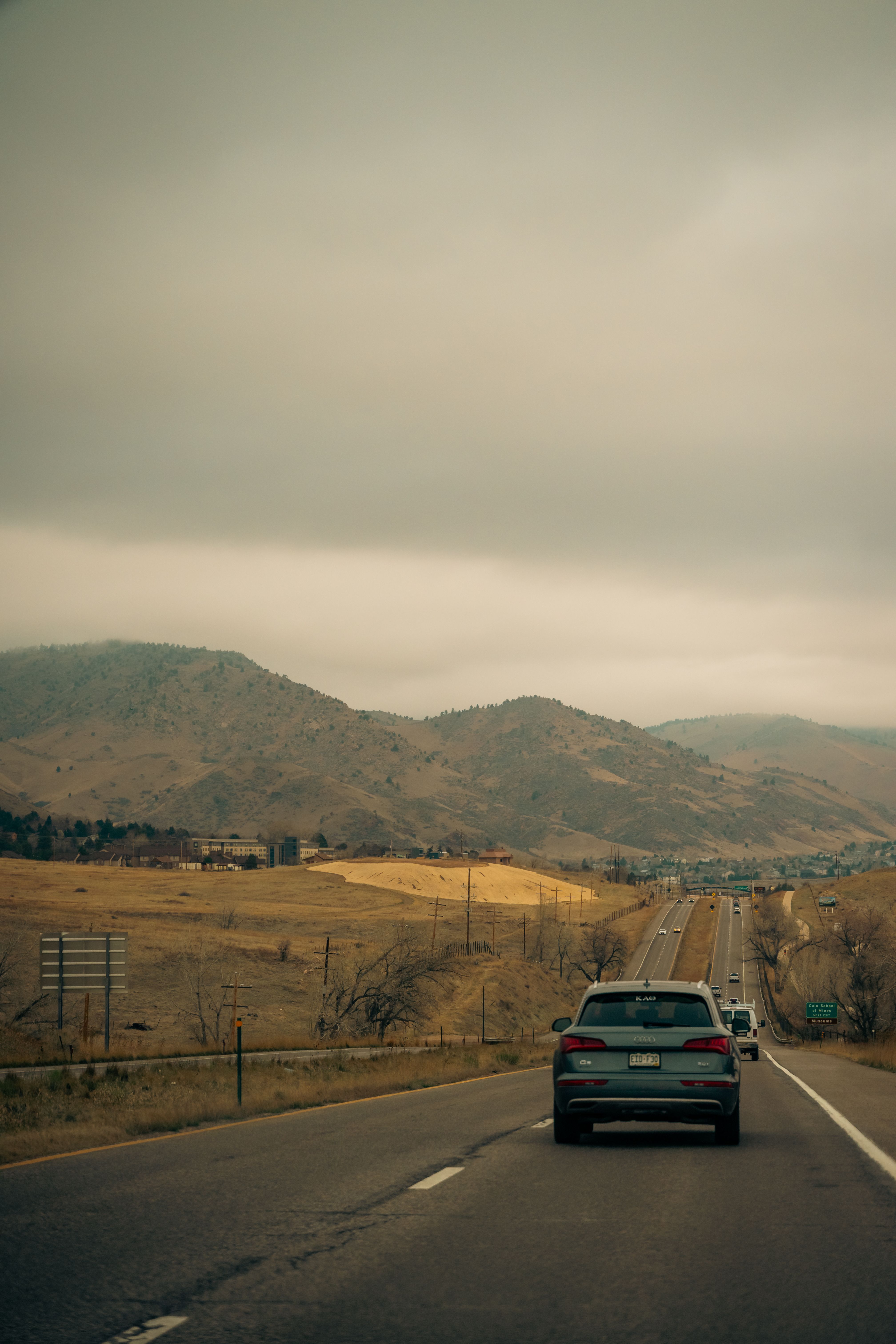 Scenic mountain road winding through dramatic landscape at golden hour