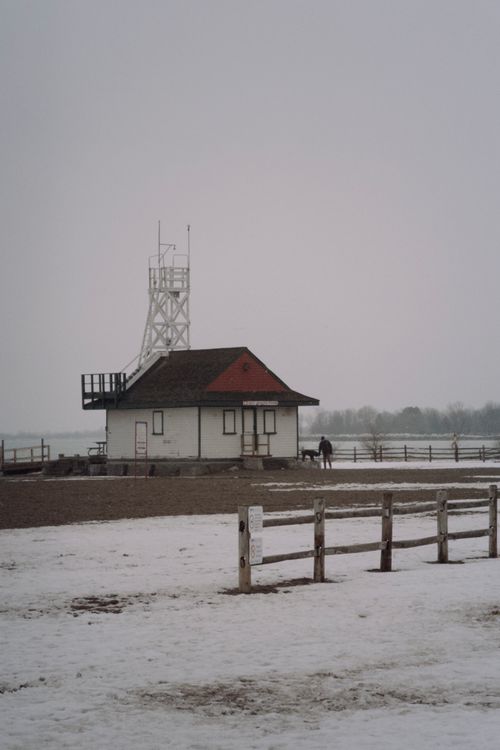 Free Snowy landscape featuring Toronto's vintage lifeguard station, capturing serene winter charm. Stock Photo