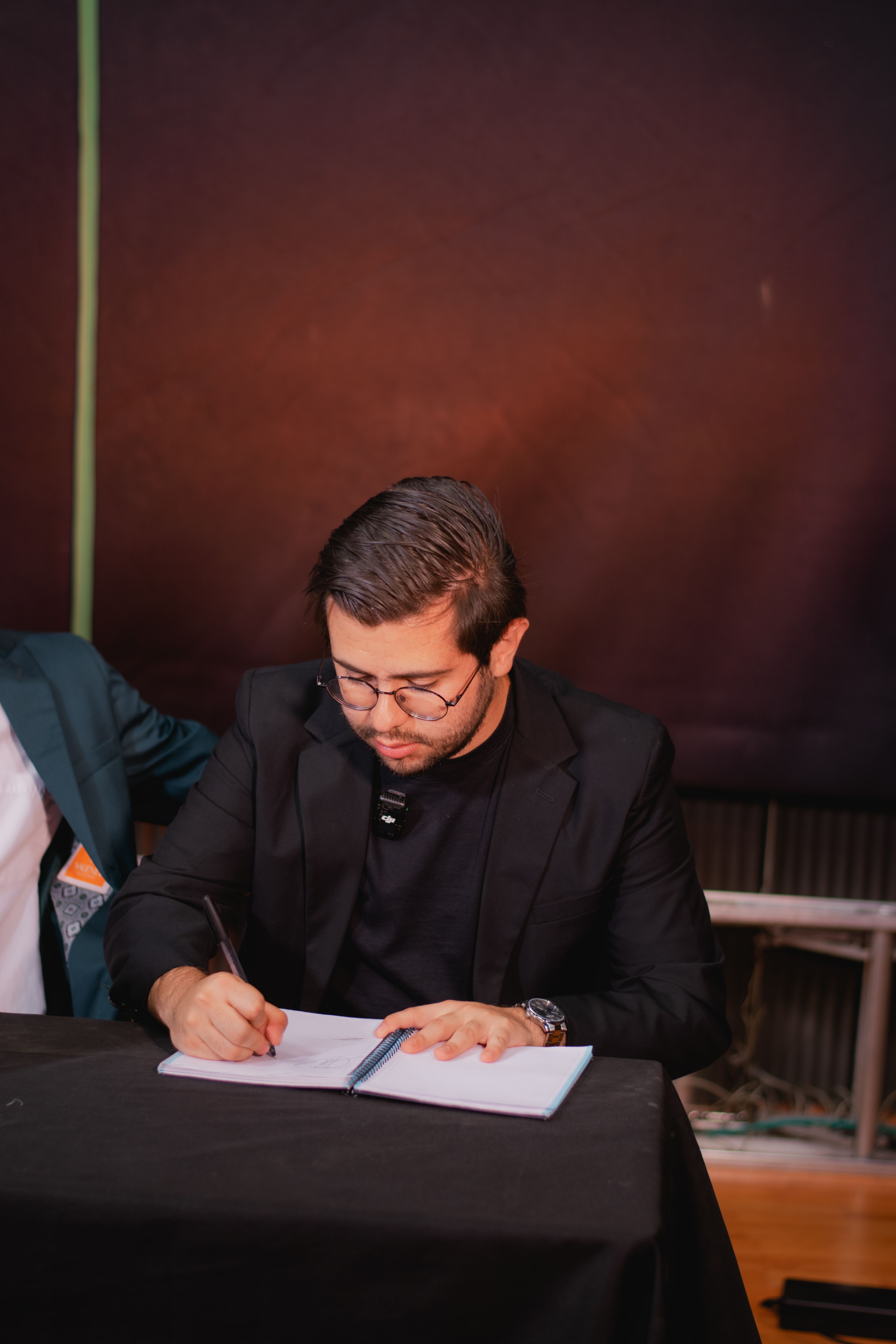 A signed promissory note and pen resting on a closing table