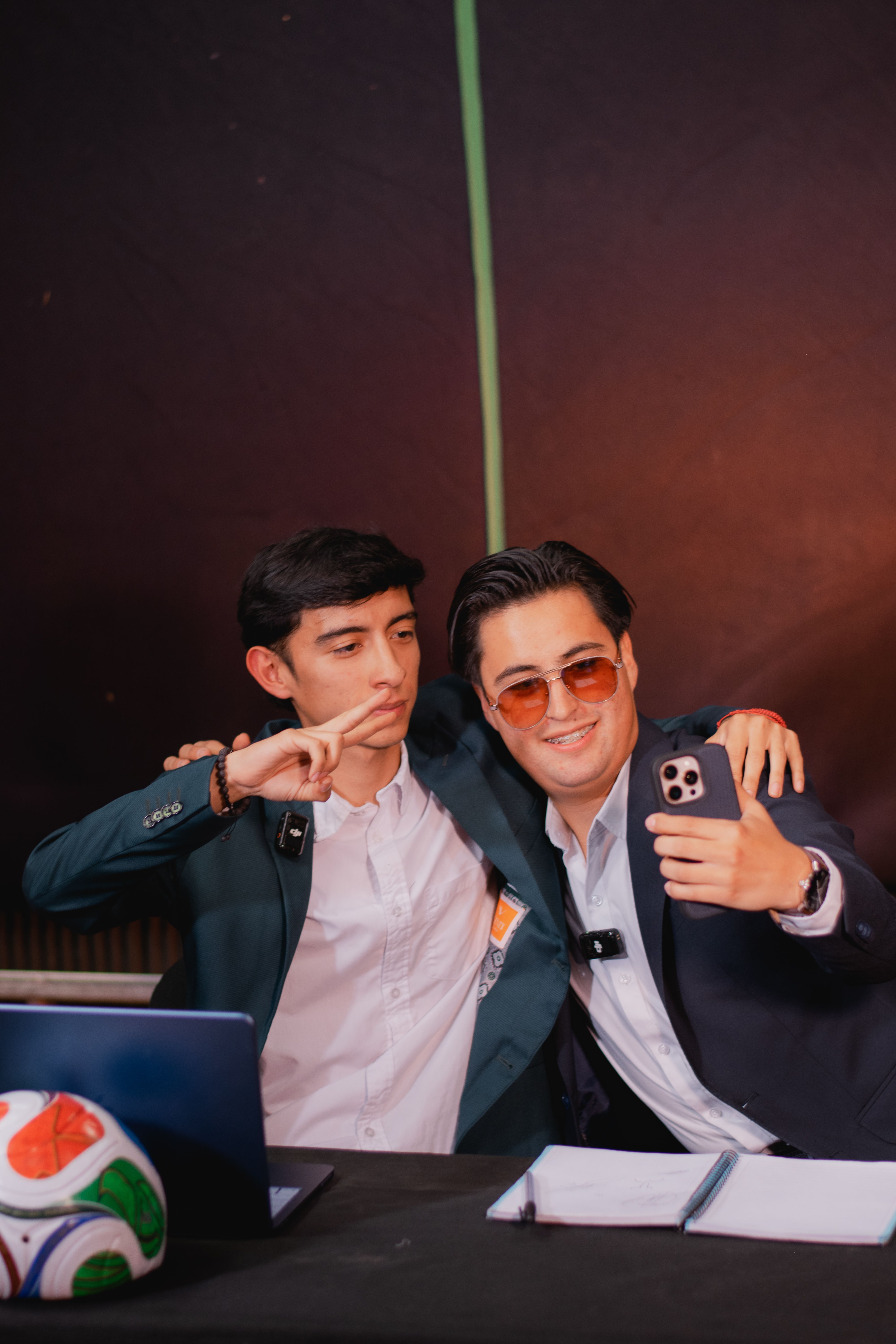 Two Young Men Taking a Selfie at a Desk