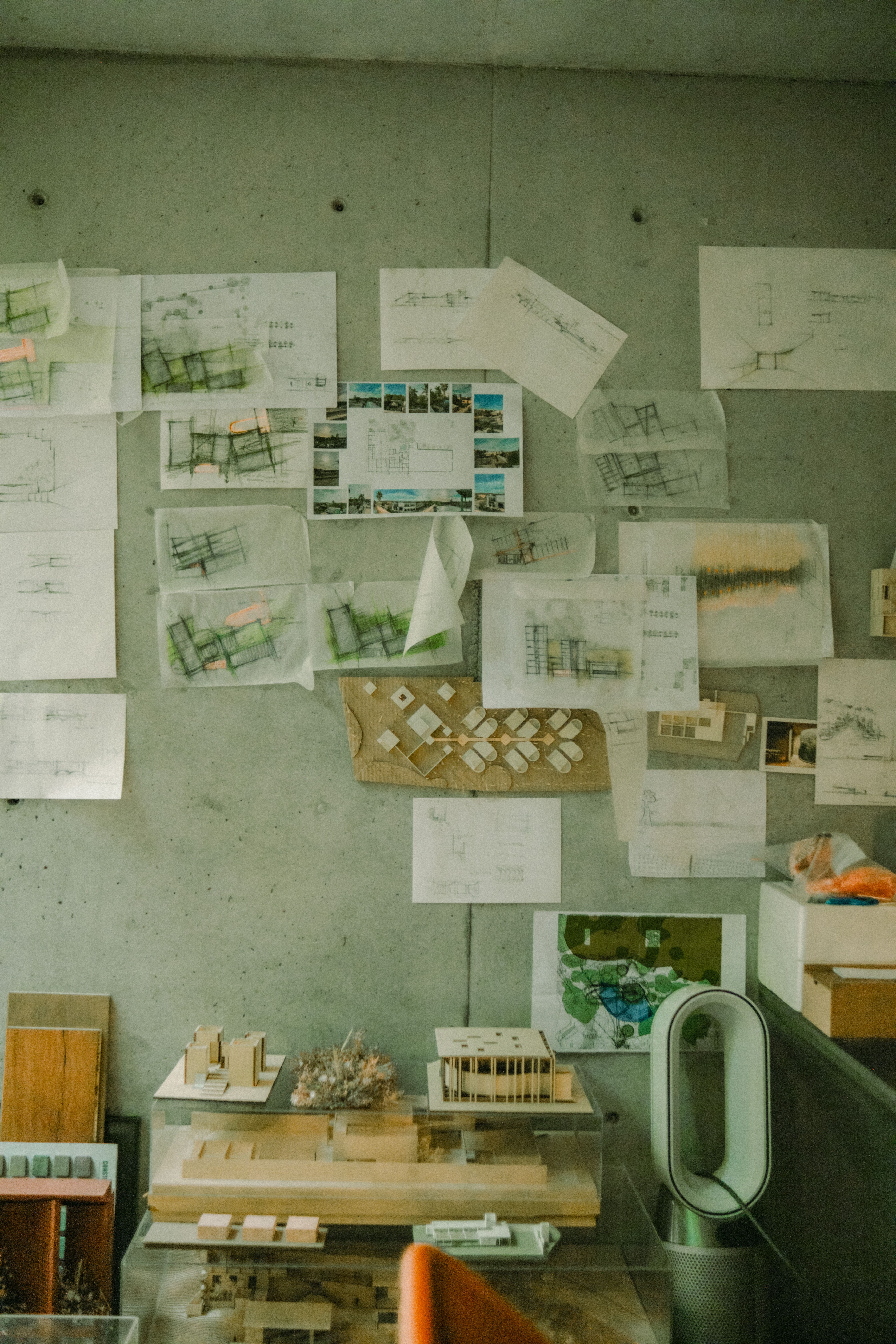 Architectural workspace with blueprints and design models on concrete — representing systematic identity work for Stripe