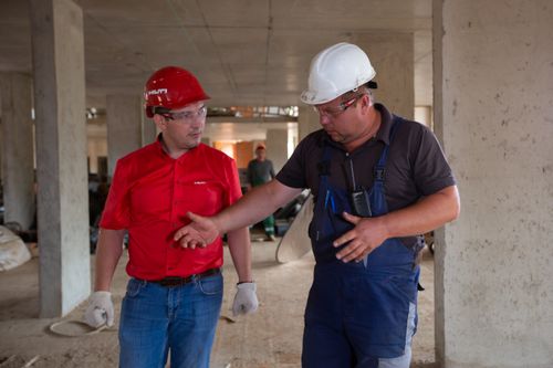 Construction workers discussing plans at a site