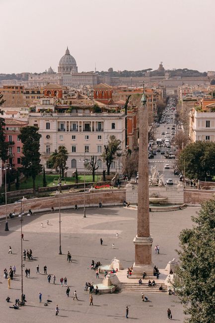 A breathtaking aerial view of Piazza del Popolo with distant St. Peter's Basilica.