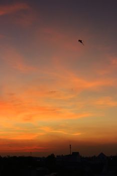 A vibrant sunset in Da Nang, Vietnam captures a solitary kite in the sky, creating a serene scene.