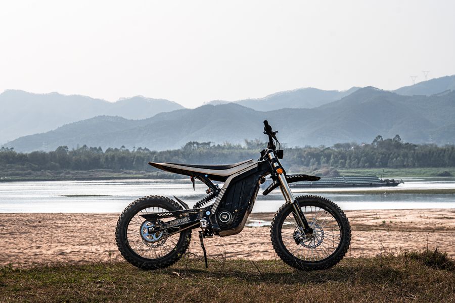 Electric dirt bike in the backcountry by the water