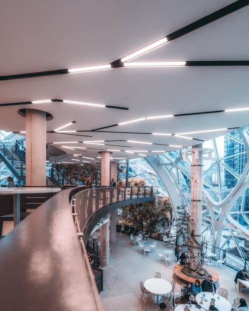 Free People Walking Inside Building With Glass Walls Stock Photo