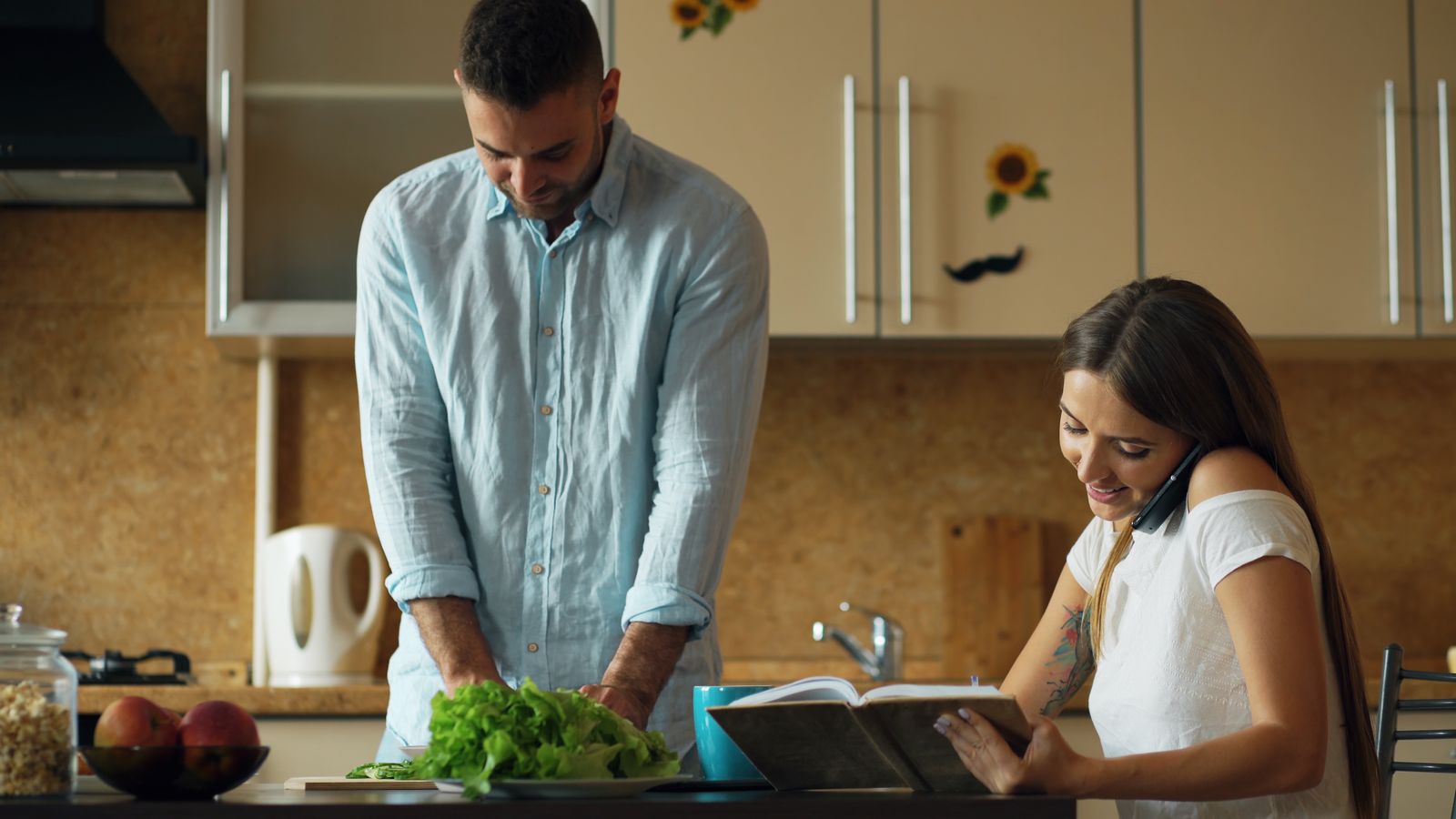 Two people preparing a meal together in a kitchen