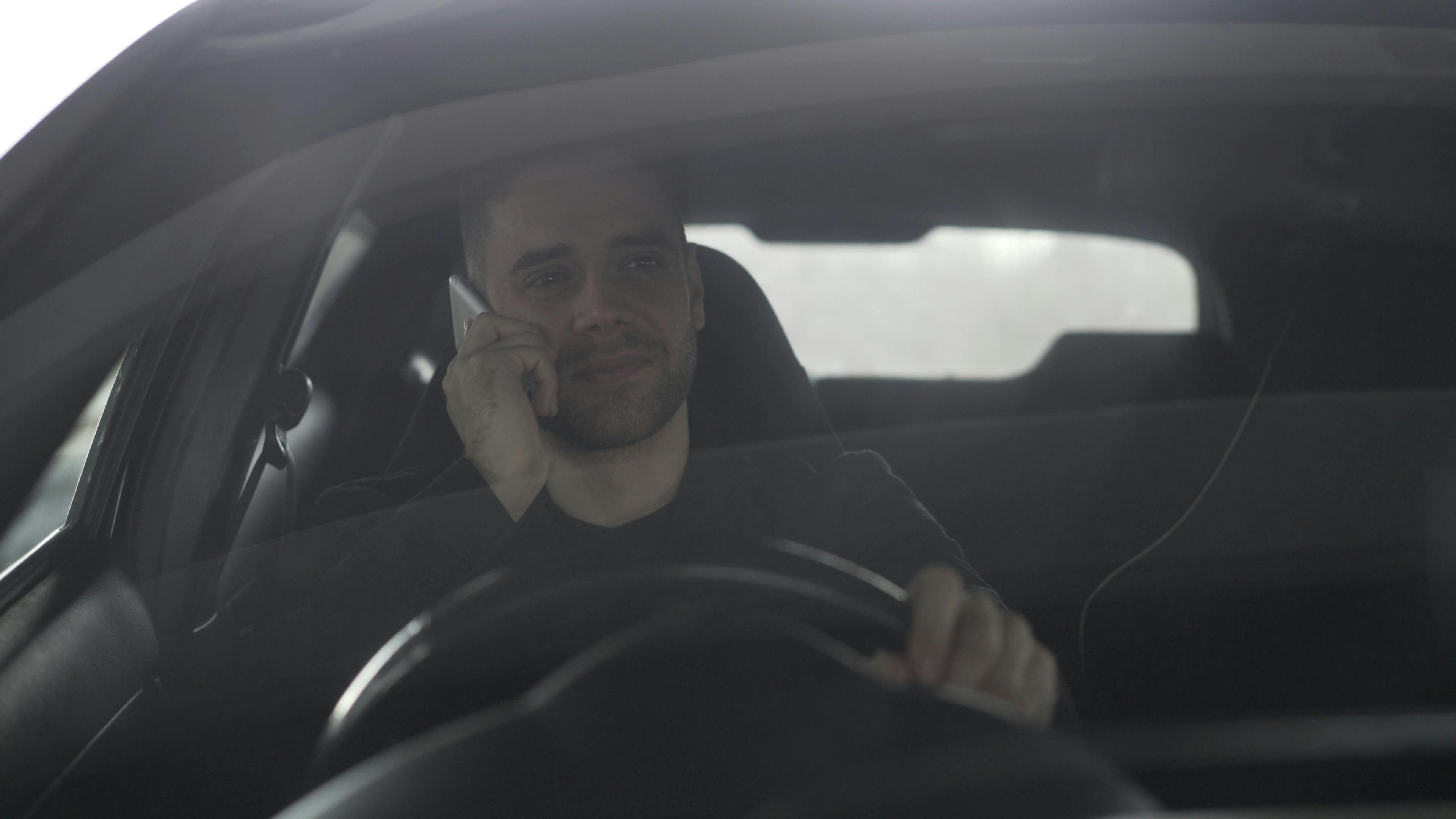 Close-up of a smartphone screen displaying The General Auto Insurance logo, held by a person.