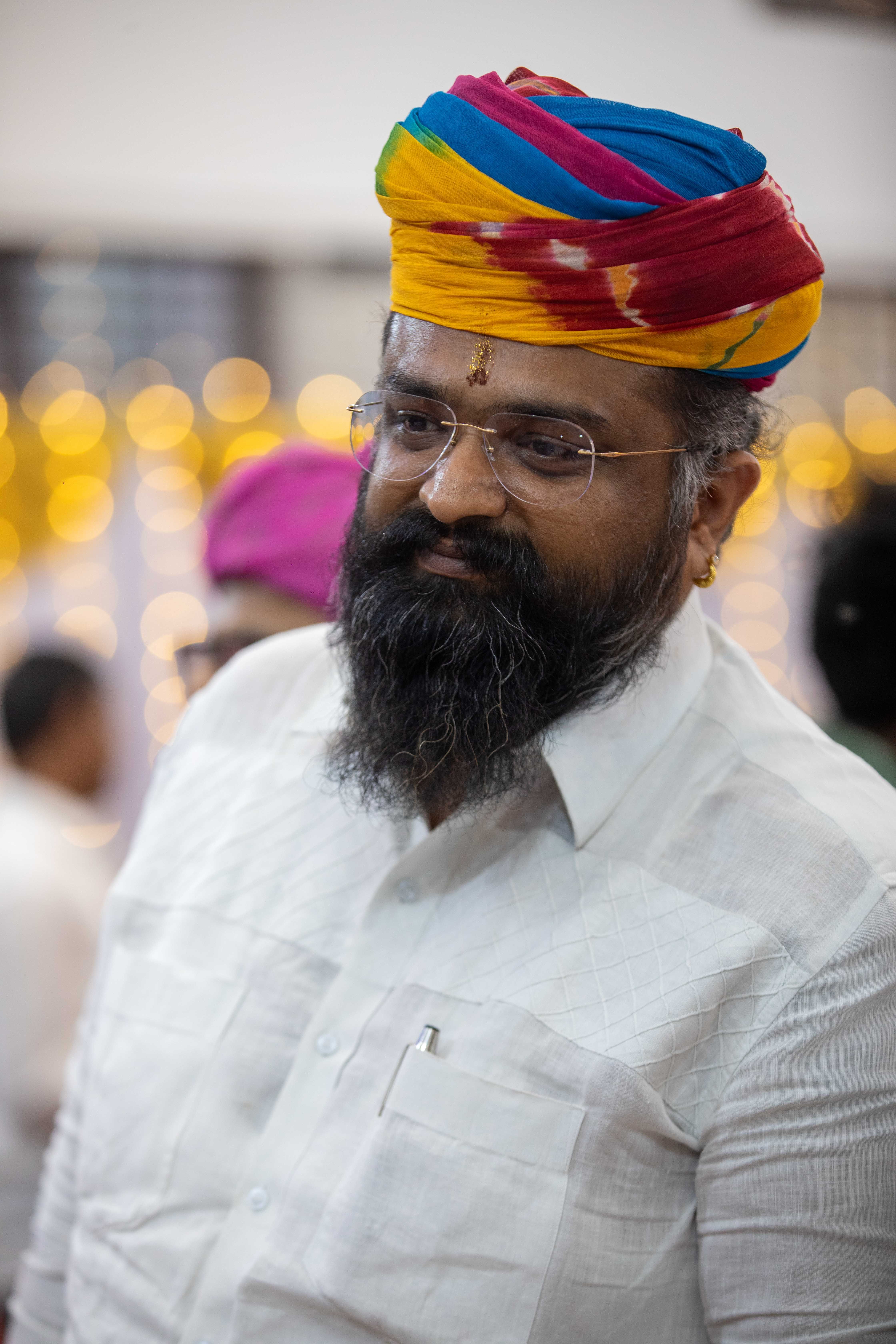 Man in Vibrant Traditional Turban at Event · Free Stock Photo