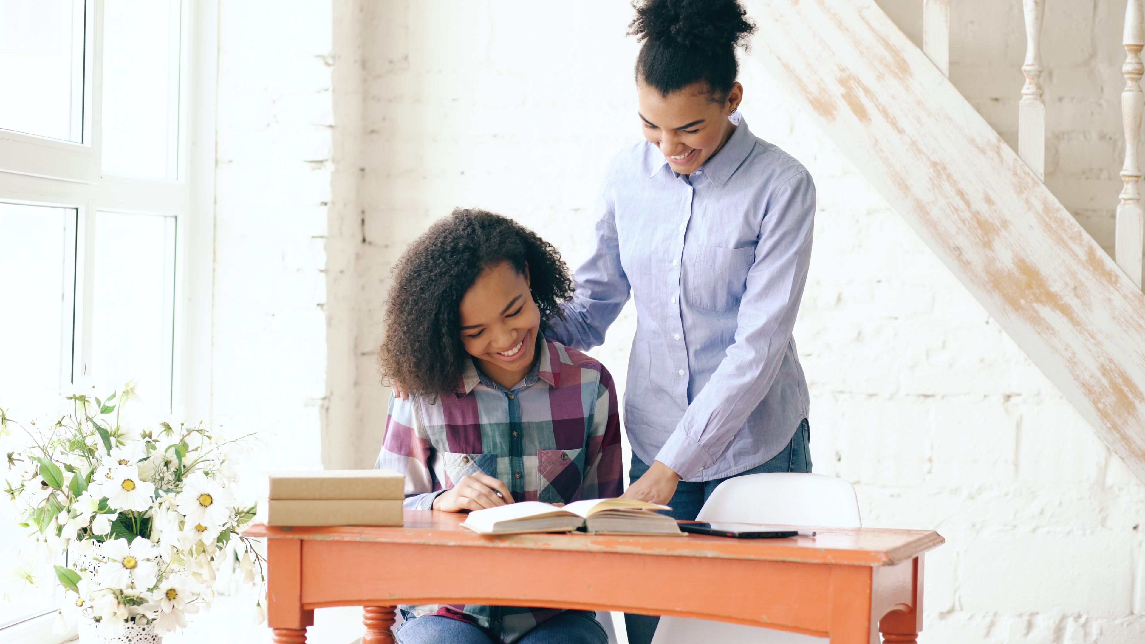 Happy siblings studying together at home · Free Stock Photo