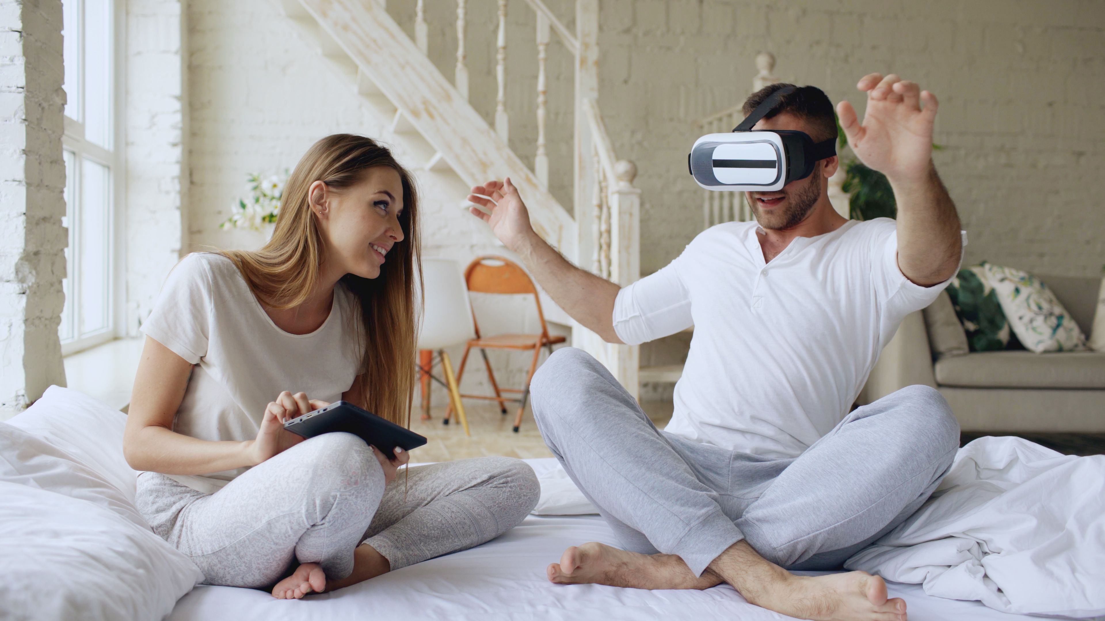 Happy couple enjoying virtual reality experience together in a cozy room. - High Quality Performance Evaluation