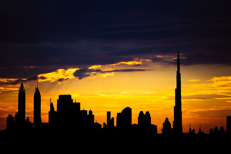 Dubai skyline silhouette at sunset, representing a UK landlord relocating to the UAE while keeping a UK rental