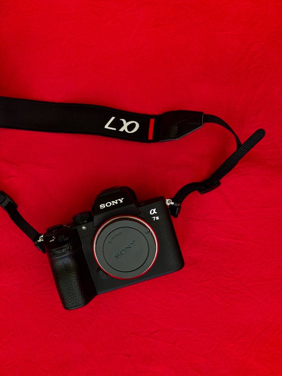Black Camera With Black Lace and A Red Background