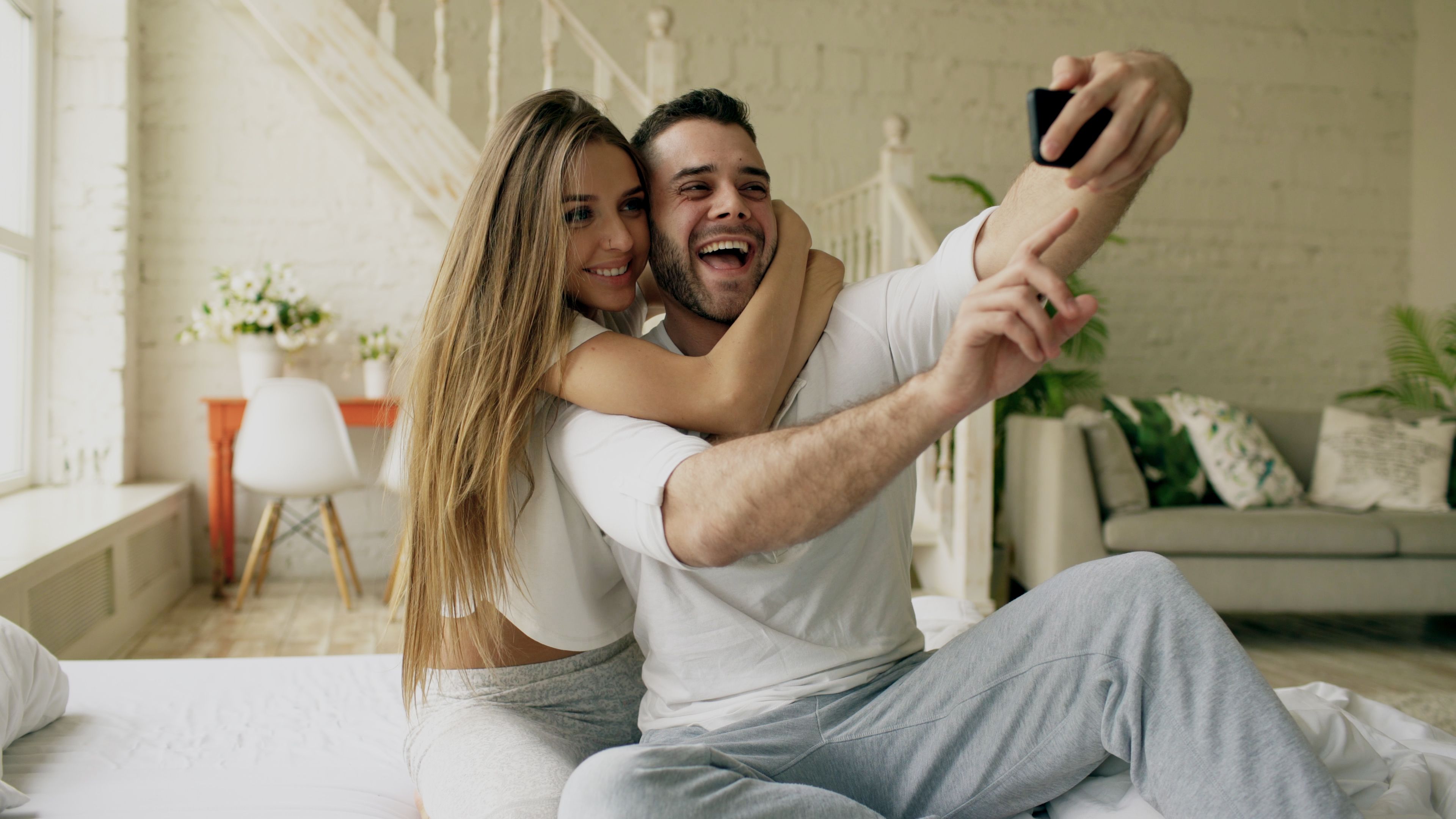 Happy Couple Taking a Selfie at Home · Free Stock Photo