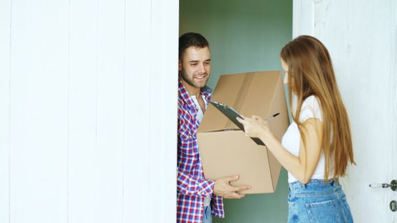 Delivery person handing a package to a customer at the door