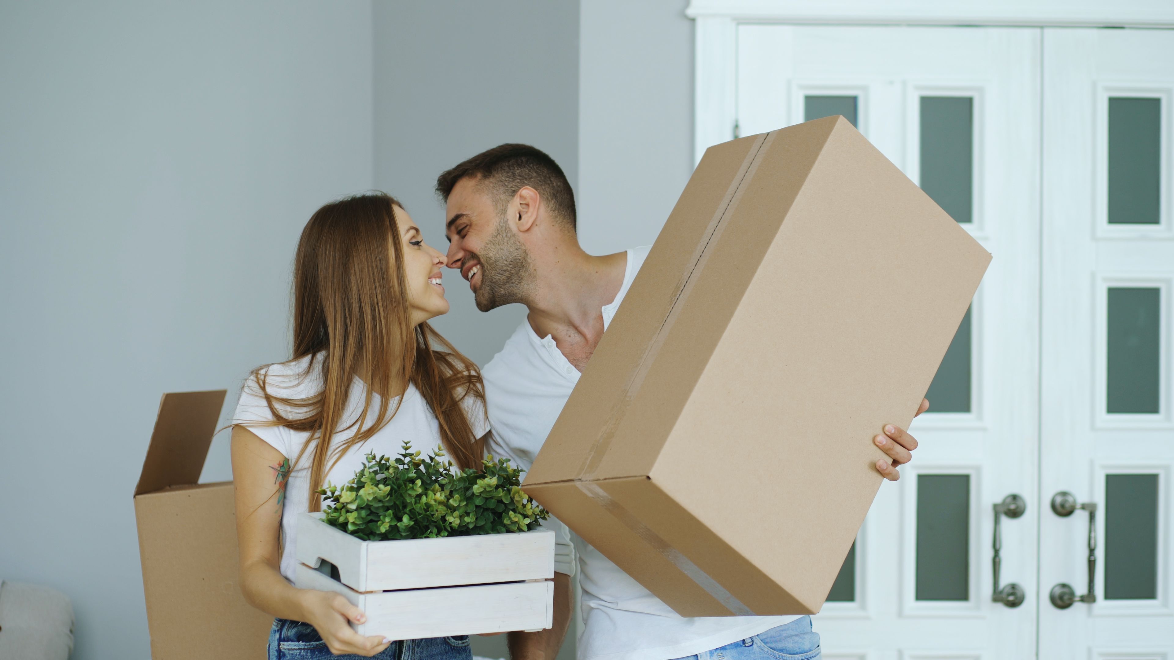 Young Couple Moving Into New Home with Boxes · Free Stock Photo