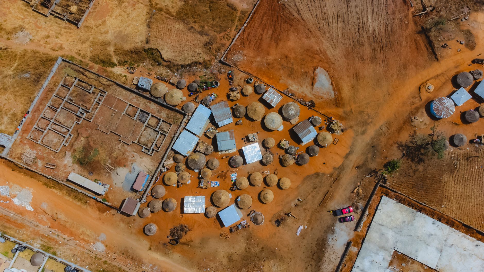 Aerial view of traditional huts and structures in Abuja, showcasing rural Nigerian architecture.