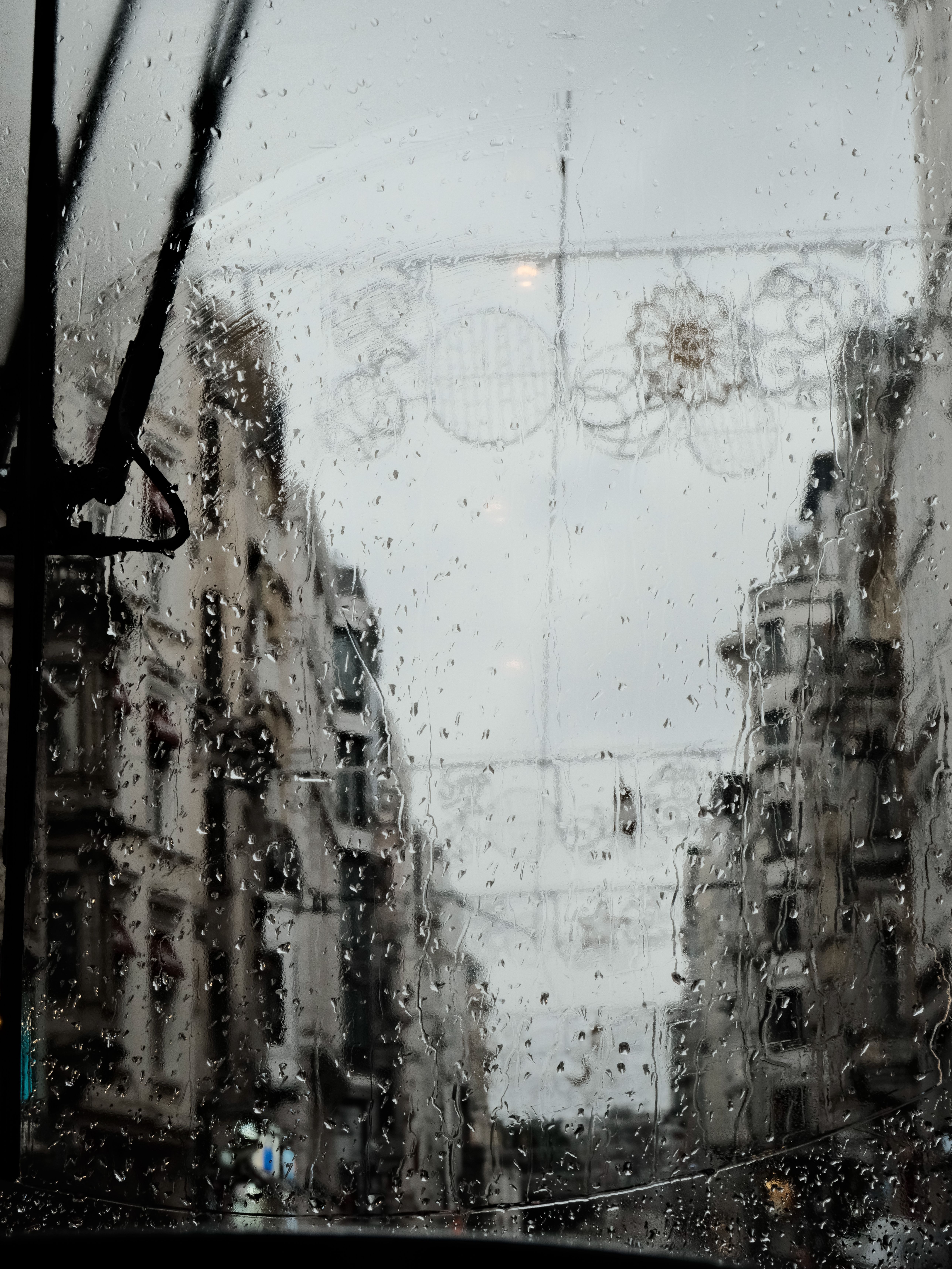 Rainy City Street Through a Bus Window · Free Stock Photo