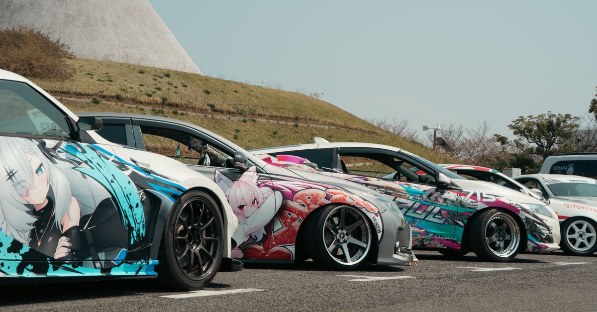 Unique street cars with anime vinyl art parked outdoors in Tokyo, ideal for showcasing vibrant car culture.